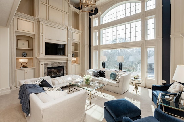 7580 NW 100th St, Johnston, IA 50131 - living room with a high ceiling, carpet floors, built in features, and a fireplace