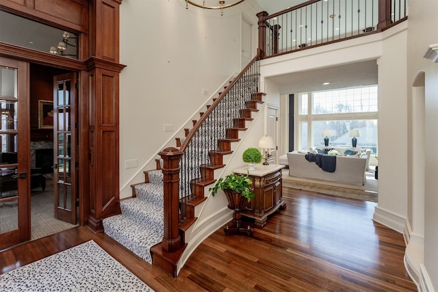 7580 NW 100th St, Johnston, IA 50131 - staircase featuring wood finished floors and a high ceiling