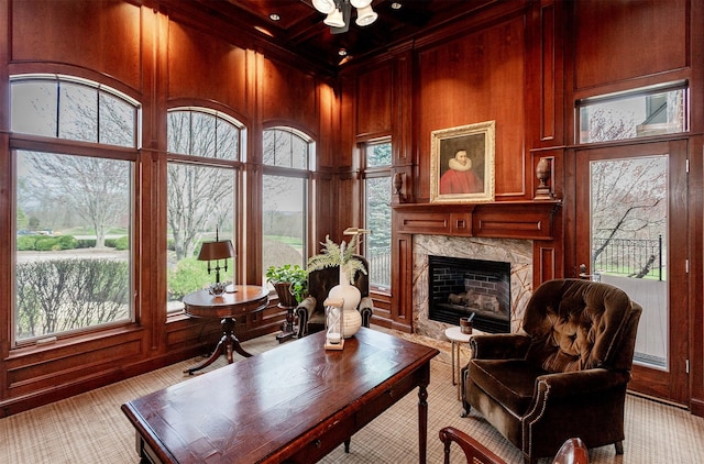 7580 NW 100th St, Johnston, IA 50131 - living room with a high end fireplace, wood walls, beamed ceiling, coffered ceiling, and ornamental molding