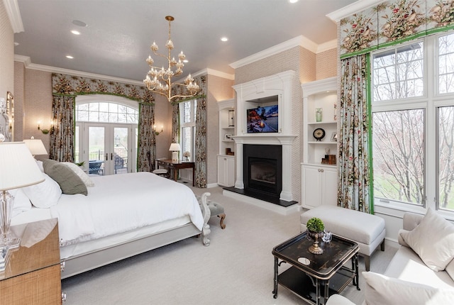 7580 NW 100th St, Johnston, IA 50131 - carpeted bedroom with crown molding, a chandelier, french doors, a fireplace with raised hearth, and wallpapered walls