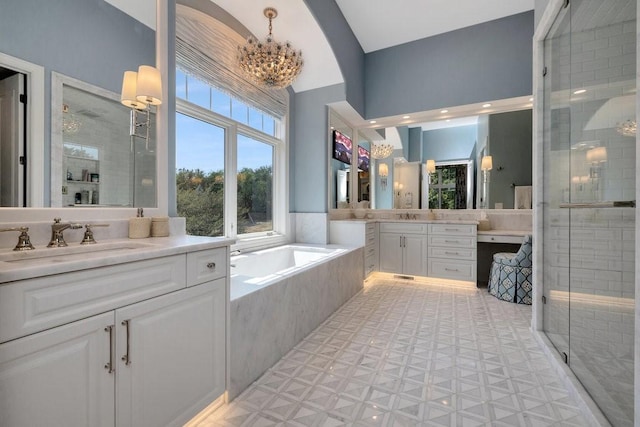 7580 NW 100th St, Johnston, IA 50131 - bathroom with two vanities, a shower stall, a garden tub, and a chandelier