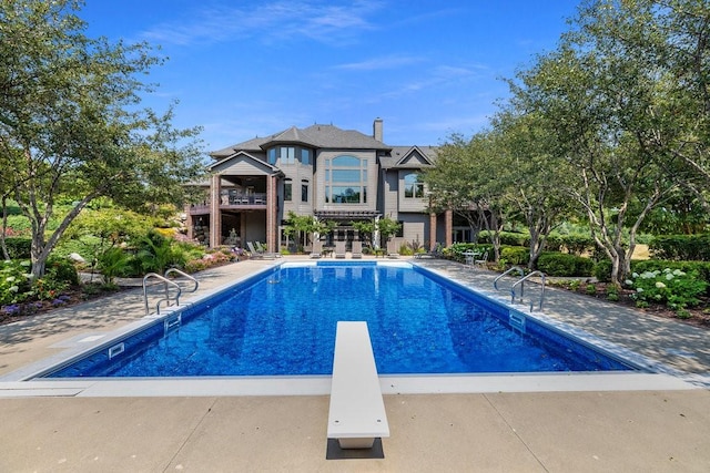 7580 NW 100th St, Johnston, IA 50131 - outdoor pool featuring a diving board and a patio area