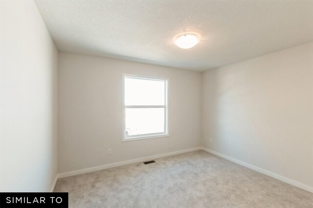 4201 NE 5th St, Ankeny, IA 50021 - carpeted empty room featuring visible vents, baseboards, and a textured ceiling