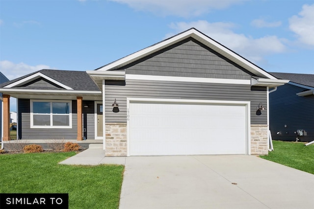 4201 NE 5th St, Ankeny, IA 50021 - view of front of home with an attached garage, stone siding, a front lawn, and concrete driveway