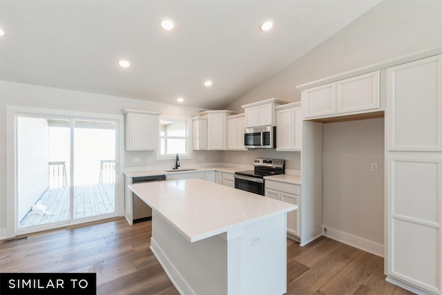 4201 NE 5th St, Ankeny, IA 50021 - kitchen with light countertops, a center island, white cabinets, appliances with stainless steel finishes, and a sink