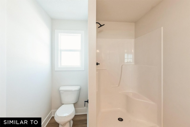 4201 NE 5th St, Ankeny, IA 50021 - full bathroom featuring a shower, wood finished floors, baseboards, and toilet