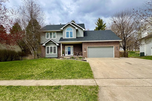2501 Ridgewood Dr, West Des Moines, IA 50265 - traditional home with a front lawn, driveway, brick siding, and a garage