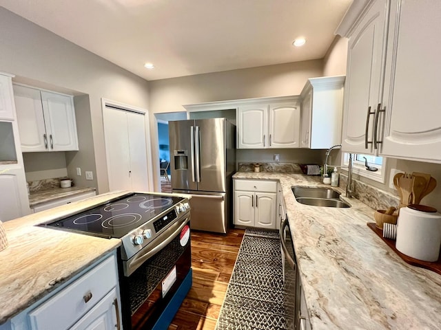 2501 Ridgewood Dr, West Des Moines, IA 50265 - kitchen with dark wood finished floors, white cabinetry, stainless steel appliances, and a sink