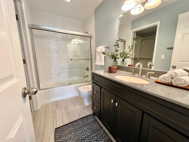 2501 Ridgewood Dr, West Des Moines, IA 50265 - full bathroom featuring toilet, vanity, and shower / bath combination with glass door