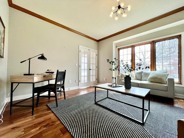 2501 Ridgewood Dr, West Des Moines, IA 50265 - living area featuring plenty of natural light, crown molding, wood finished floors, and an inviting chandelier