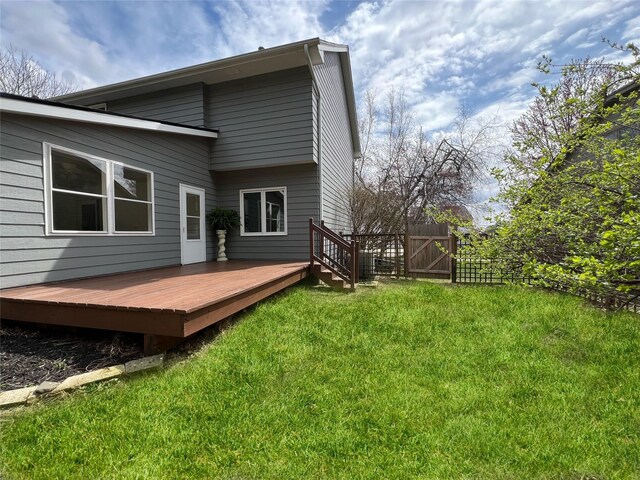 2501 Ridgewood Dr, West Des Moines, IA 50265 - back of house with a gate, a lawn, fence, and a deck
