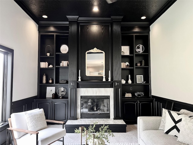 2501 Ridgewood Dr, West Des Moines, IA 50265 - carpeted living room with built in features, a fireplace, ornamental molding, and a decorative wall