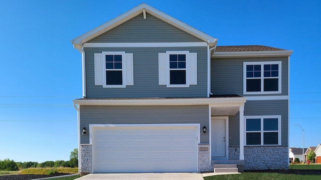 view of front of house featuring stone siding, a garage, and concrete driveway