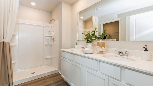 1048 34th St SE, Altoona, IA 50009 - full bathroom with a walk in shower, double vanity, visible vents, and a sink