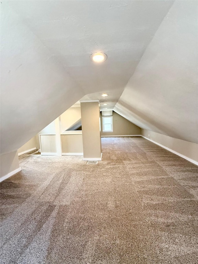 bonus room with carpet flooring, baseboards, and lofted ceiling