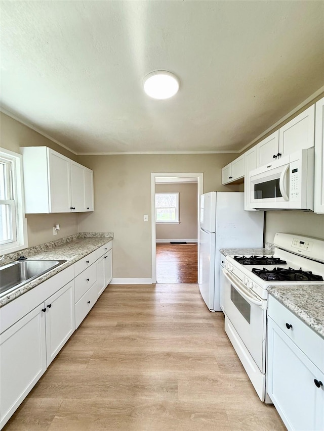 kitchen featuring light wood-type flooring, white appliances, white cabinetry, and ornamental molding