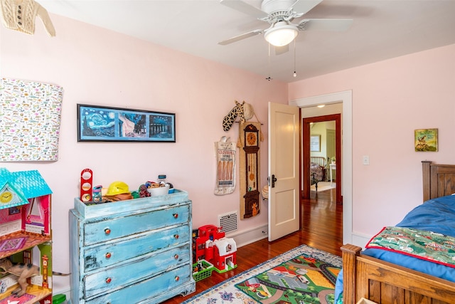 bedroom featuring wood finished floors, a ceiling fan, and visible vents
