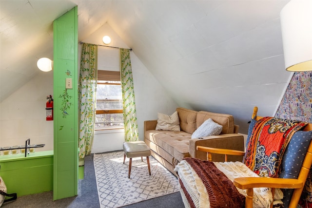 sitting room featuring lofted ceiling and carpet floors