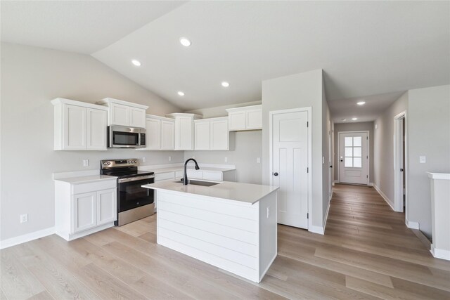 4421 NW Olivia Ln, Ankeny, IA 50023 - kitchen featuring stainless steel appliances, a sink, an island with sink, light wood-type flooring, and white cabinets
