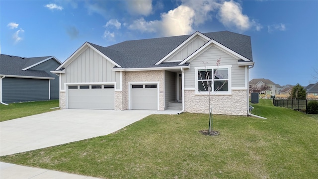 craftsman-style home with board and batten siding, stone siding, a front lawn, an attached garage, and concrete driveway