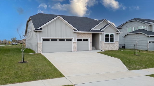 craftsman-style house with board and batten siding, a front yard, stone siding, and driveway