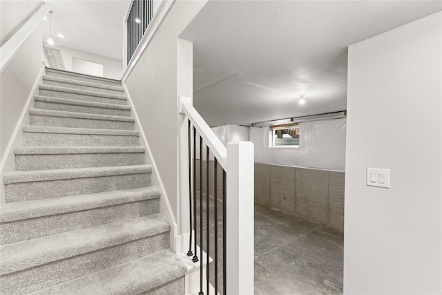 staircase with concrete floors