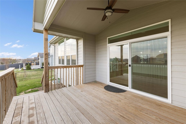 deck featuring fence, a lawn, and ceiling fan