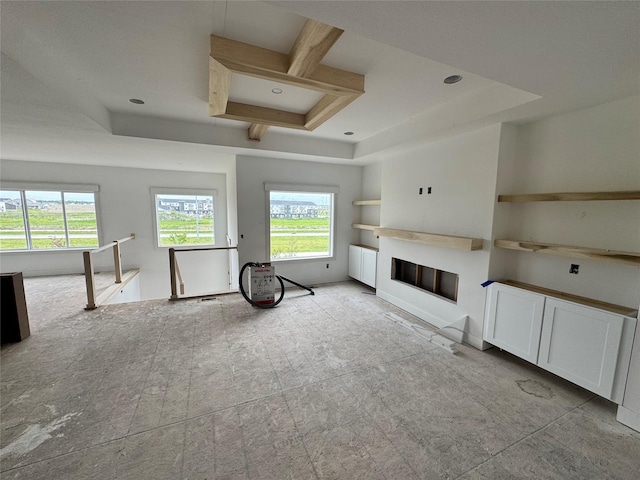 850 NW Frescott Cir, Waukee, IA 50263 - unfurnished living room with a tray ceiling and a glass covered fireplace