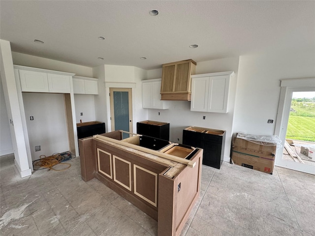 850 NW Frescott Cir, Waukee, IA 50263 - kitchen featuring a kitchen island and white cabinets