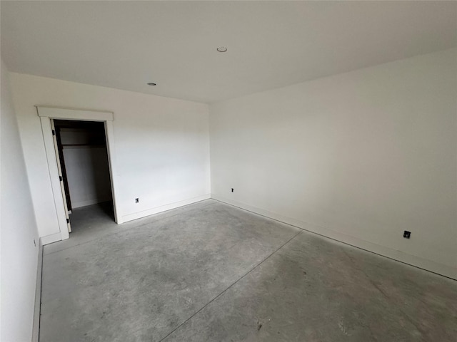 850 NW Frescott Cir, Waukee, IA 50263 - unfurnished bedroom featuring concrete flooring and baseboards