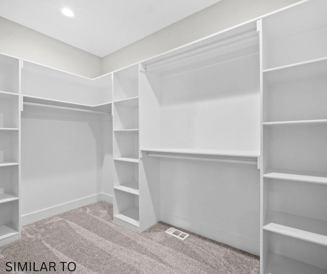 spacious closet with visible vents and carpet