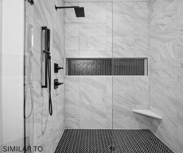 full bath featuring a tile shower