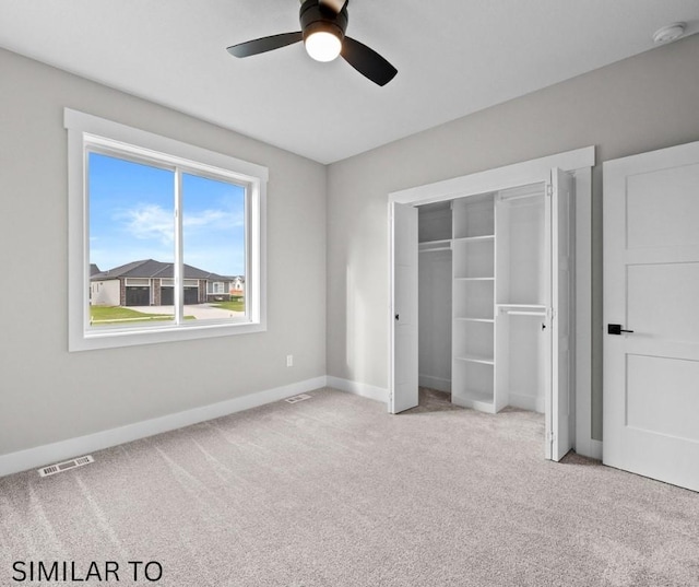 unfurnished bedroom featuring a closet, carpet flooring, visible vents, and baseboards