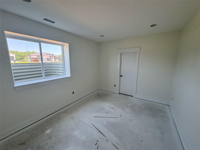 5557 165th St, Urbandale, IA 50323 - unfurnished room featuring baseboards and unfinished concrete floors