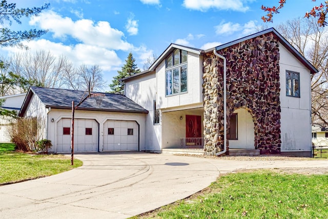 traditional-style house with an attached garage, stone siding, covered porch, stucco siding, and driveway