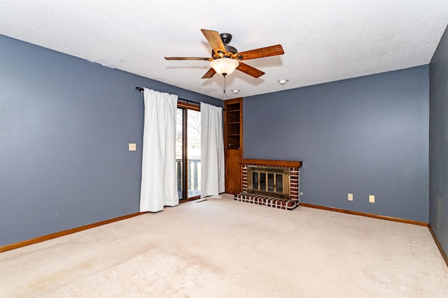 carpeted empty room with baseboards, a ceiling fan, and a brick fireplace