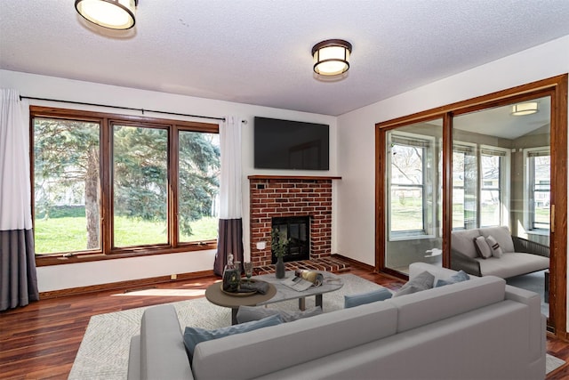living area with plenty of natural light, a textured ceiling, and baseboards