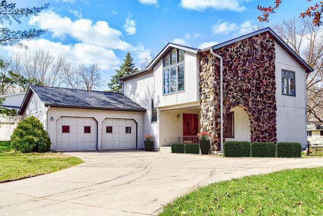 traditional-style home featuring a garage, driveway, stone siding, and stucco siding