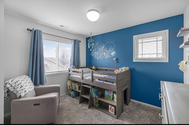 carpeted bedroom featuring visible vents, baseboards, and multiple windows