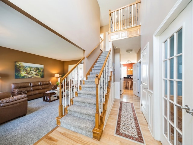 2705 147th St, Urbandale, IA 50323 - entryway with stairs, a towering ceiling, and light wood-style floors