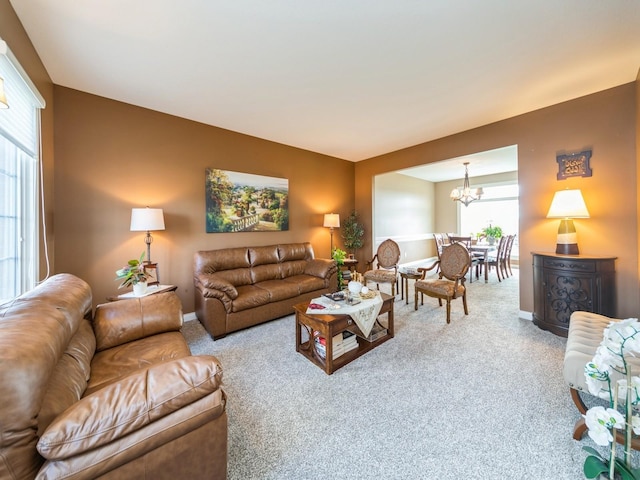 2705 147th St, Urbandale, IA 50323 - carpeted living room featuring baseboards and a notable chandelier