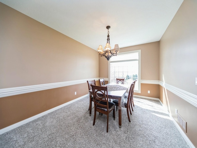 2705 147th St, Urbandale, IA 50323 - carpeted dining area with baseboards, visible vents, and a chandelier
