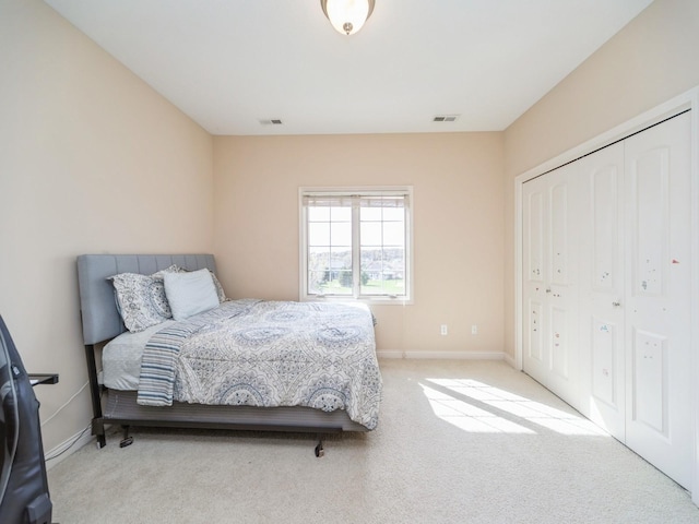 2705 147th St, Urbandale, IA 50323 - bedroom featuring a closet, baseboards, visible vents, and light colored carpet
