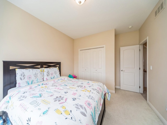 2705 147th St, Urbandale, IA 50323 - bedroom with baseboards, visible vents, a closet, and light colored carpet