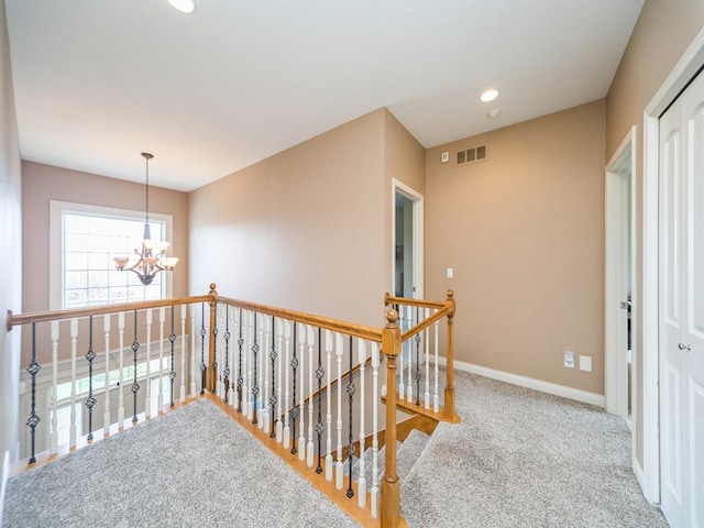 2705 147th St, Urbandale, IA 50323 - corridor with baseboards, recessed lighting, visible vents, an inviting chandelier, and an upstairs landing