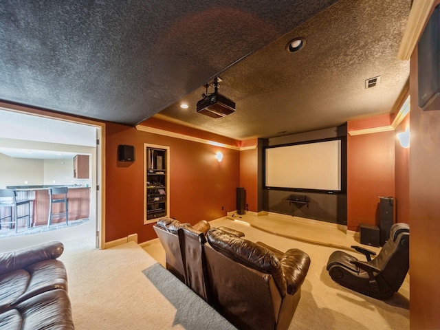 2705 147th St, Urbandale, IA 50323 - home theater with visible vents, carpet floors, a textured ceiling, and ornamental molding