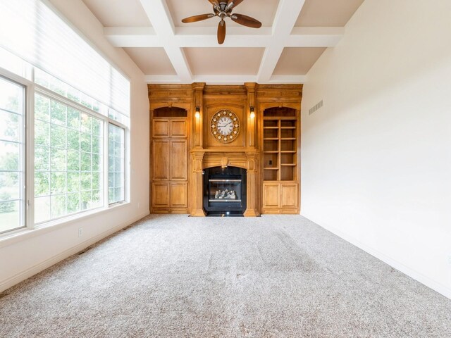 2705 147th St, Urbandale, IA 50323 - unfurnished living room with plenty of natural light, a ceiling fan, a glass covered fireplace, carpet, and coffered ceiling