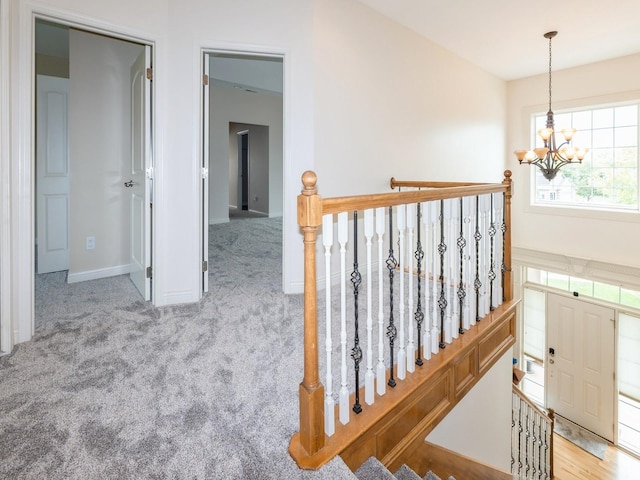 2705 147th St, Urbandale, IA 50323 - stairs with a chandelier and carpet flooring