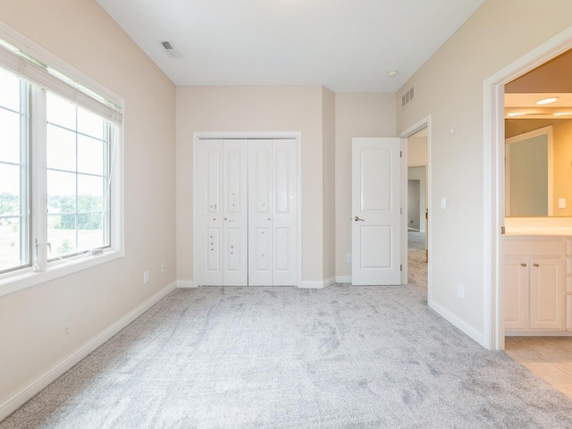2705 147th St, Urbandale, IA 50323 - unfurnished bedroom with light colored carpet and a closet