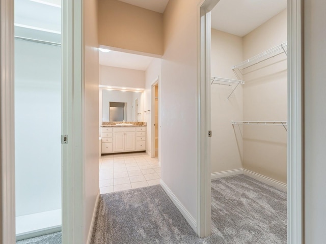 2705 147th St, Urbandale, IA 50323 - walk in closet with light carpet and light tile patterned flooring